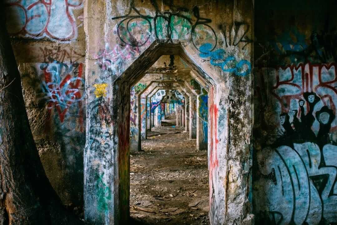 Dark urban corridor with graffiti